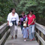 Group walks out of forest on boardwalk trail.