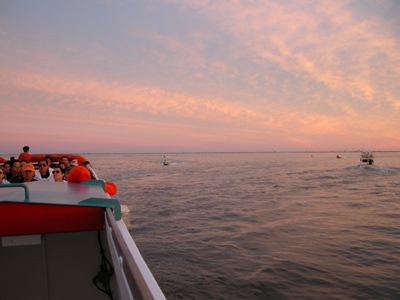 Riders on ferry view September sunset over the Great South Bay.