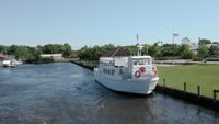 Patchogue-Watch Hill Ferry Terminal site with boat on river.