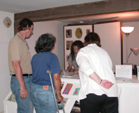 Group looks at books at sales desk.