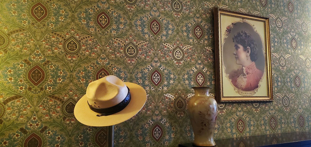 a ranger flat hat sits on a stanchion next to a portrait of Ida McKinley