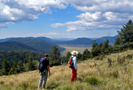 Photo of hikers on the Cerro Grande Trail at Bandelier National Monument Photo of hikers on the Cerro Grande Trail at Bandelier National Monument
