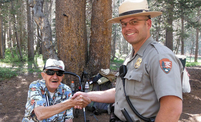Pearl Harbor survivor Hal Mayo, a US Navy veteran (seated), shares a moment with Yosemite Ranger Gary Bias, a US Army veteran. Pearl Harbor survivor Hal Mayo, a US Navy veteran (seated), shares a moment with Yosemite Ranger Gary Bias, a US Army veteran.