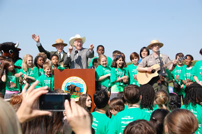 Ranger Jeff on stage with Secretary of Interior and Director of the National Park Service and lots of kids