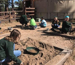 Students digging in sand pits