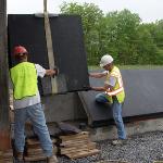 Installing the final section of the Memorial Plaza wall