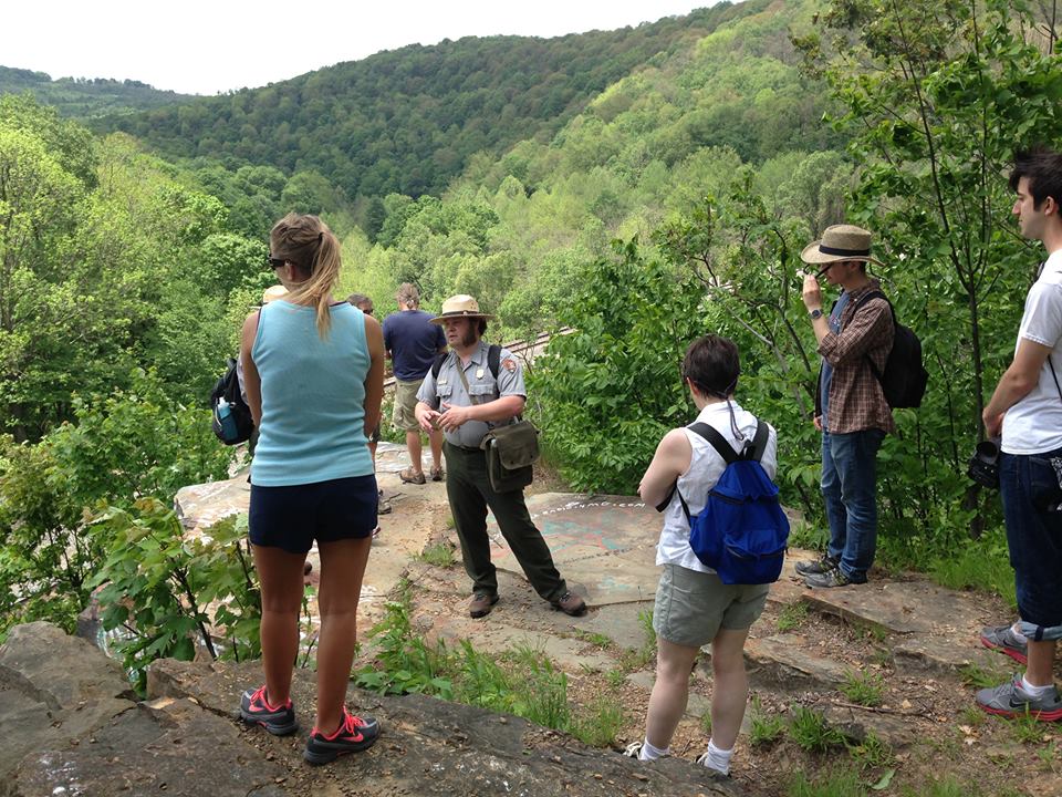 Ranger Doug Bosley and visitors exploring the Path of the Flood Trail
