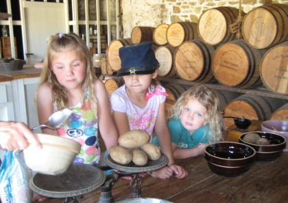 young visitors weigh food at the commissary