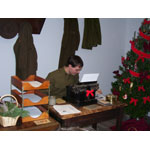 A soldier types a letter to send home.