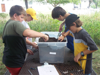 Workshop participants performing a mock archaeological dig.