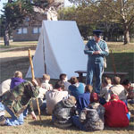 Fort Scott ranger dressed as an infantry soldier giving programs to scouts.