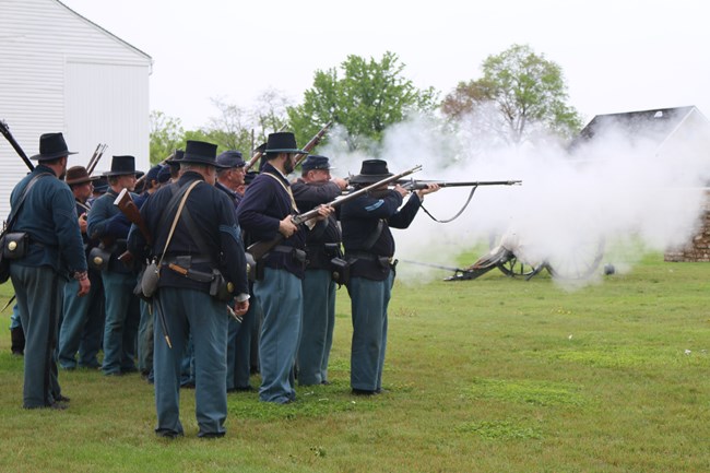 Soldiers firing Civil War Weapons