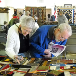 Examining a quilt-from quilt symposium in 2010.