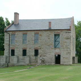 The stone commissary was originally begun as a bastion, evidence of which can be seen on the first level.