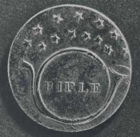 Rifle Regiment button showing a bugle, bell to the left, with circular bend, mouthpiece horizontal, the word “Rifle” within the bend, 13 five point stars in two arcs above. Pattern (die) lines tend towards diffuse. 20 mm in diameter.