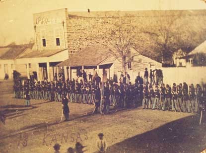 soldiers from 13th Kansas line up in downtown Fort Smith in front of commercial buildings