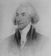 a man with nicely cropped white hair is wearing a a fine jacket with a tall white collar
