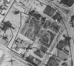 an overhead view of a city. An outline of a angular building is drawn on top.