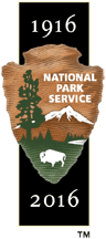 an NPS arrowhead on a black band. on that in white numbers "1916 - 2016" there is a stark contrast in the arrowhead and band colors.