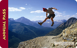 Federal Lands Pass 2012: a man jumps from a mountain cliff and seems to pause against a blue silouette of peaks