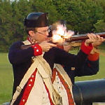 Man in Revolutionary War uniform firing a musket.