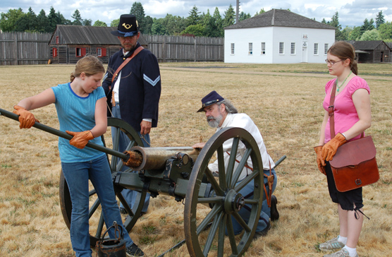 participants in the ELP assist rangers in a cannon drill