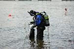 NCRI Archaeologist Jacqueline Marcotte prepares to excavate in the Columbia River. The PVC square under her arm is strung with a wire cord grid, allowing her to map objects underwater.