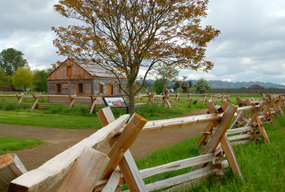 View of the fence line and replica of Village House 2
