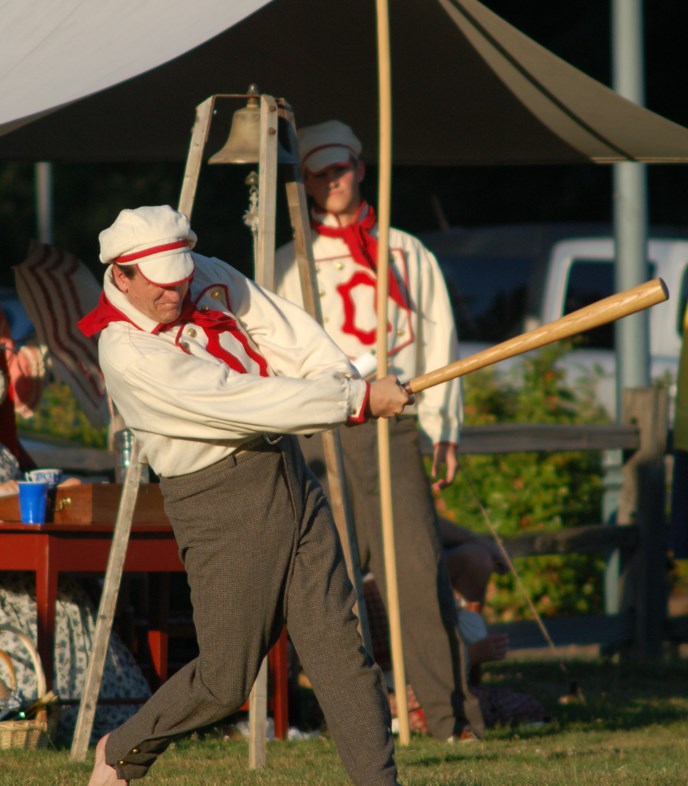 Volunteer Brett Oppegaard, costumed as a member of the Occidental Base Ball Club of Vancouver, swings a bat during the park's annual vintage base ball event.