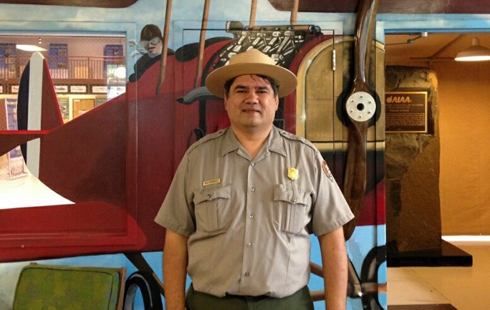 Photo of Dr. Bob Cromwell in NPS uniform inside Pearson Air Museum
