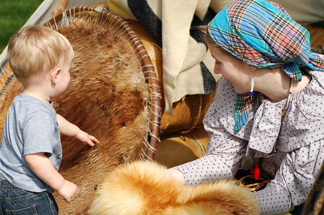 A young visitor learns about beaver fur.
