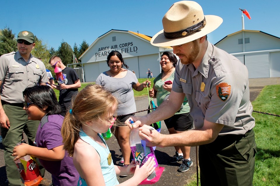 National Park Ranger helping kids with activites at Yuri's Night