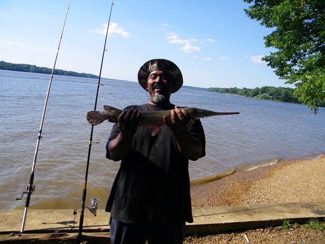 A Fort Washington fisherman with a healthy Longnose Gar.