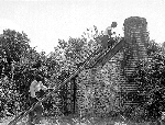 Community members repair roof on an outbuilding on the grounds of Cedar Hill in the 1920s.