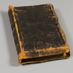 A worn leather-bound Bible embossed with "Frederick Douglass" on the cover.