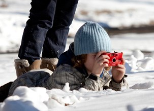 Youth taking photos in a winter landscape