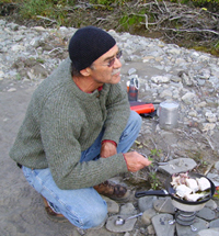Sculptor Hugh McPeak cooks his dinner while on the 2005 Artist in Residence Patrol.