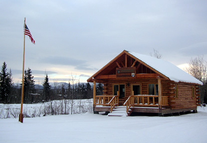 Bettles Ranger Station in winter snow and light.