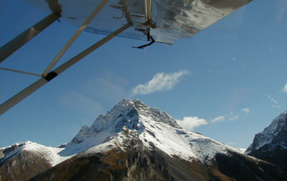 View of snowy mountain from an airplane.