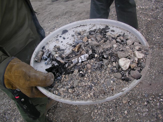 A ranger demonstrates how to build a campfire.