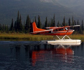 Float plane taking off of an arctic lake.