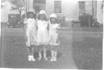 Girls stand behind Officer's Quarters, c. 1920.