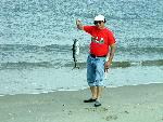 Fisherman catches a small tuna at Sandy Hook