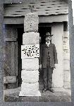 Man poses with gunpowder to fire 16-inch gun.
