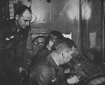 Soldiers operating equipment inside radar van.