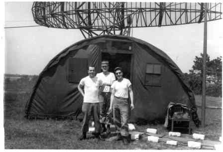 Soldiers outside a quanset hut with radar equipment, 1950s.