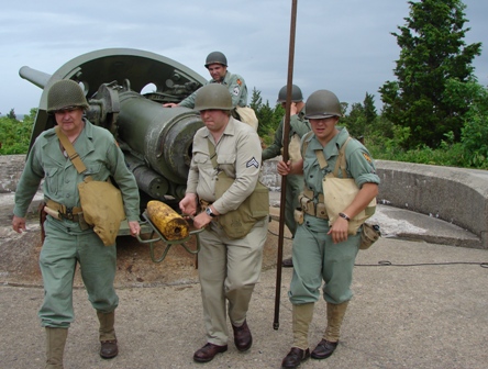 Army Ground Forces Association volunteers demonstrate how to load and unload a six-inch gun at Fort Hancock's Battery Gunnison.