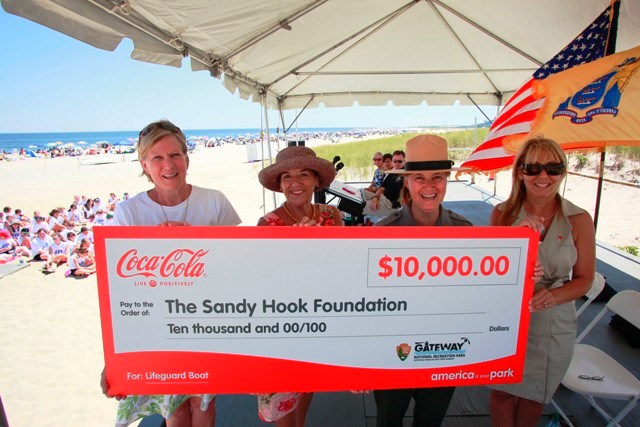 As part of Coca-Cola’s America Is Your Park program, Linda Canzanelli, Superintendent of Gateway National Recreation Area, center right, and Betsy Barrett, President of the Sandy Hook Foundation, left, accept a$10,000 donation to Sandy Hook - Gateway National Recreation Area from Coca-Cola Refreshments’ Dori Silverman, right, and New Jersey Division of Travel & Tourism’s Phyllis Oppenheimer, center left,  on behalf of New Jersey Lt. Governor Kim Guadagno, at Sandy Hook, N.J., Wednesday, July 27, 2011.