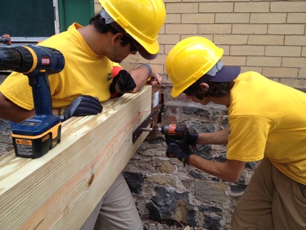 Phil Young and Louie Rodriguez work together to rebuild the historic porch on Fort Hancock's Building 26 as part of the crew from New Jersey Youth Corps of Phillipsburg.
