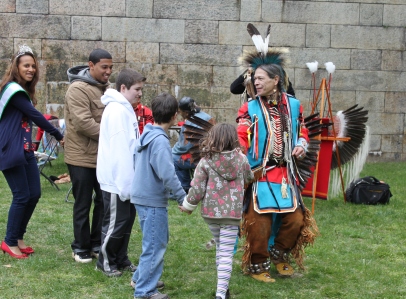 A member of Red Storm invites visitors to join in a Native American dance.